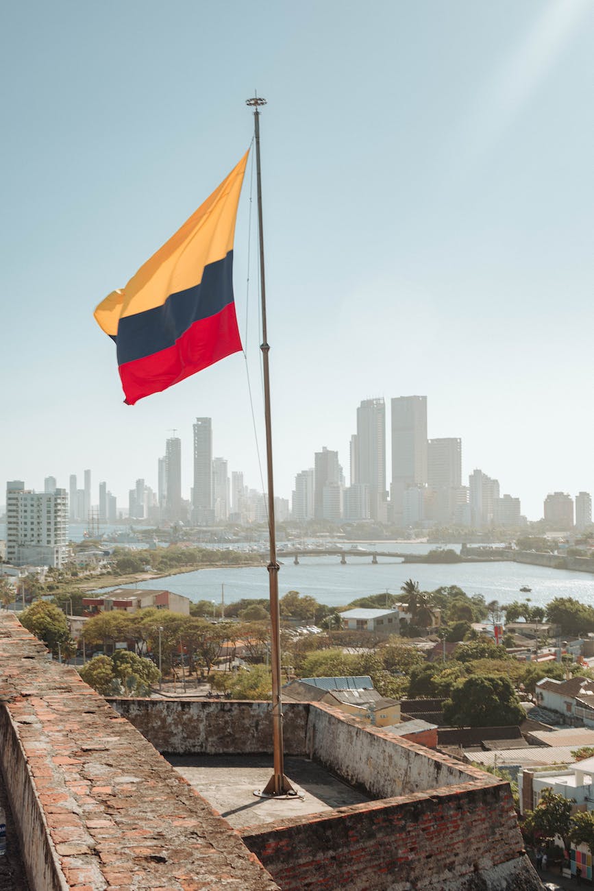colombian flag on the background of the cartagena skyline