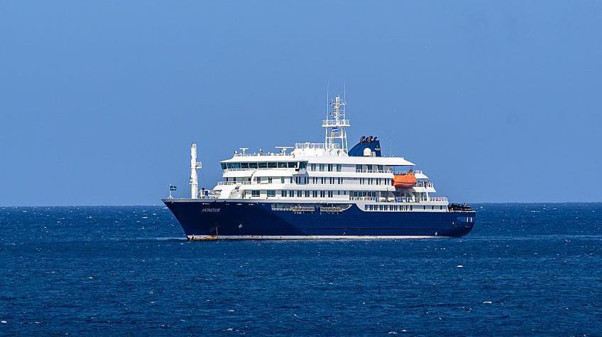 Imagen de un barco de cruceros en el mar con personas a bordo