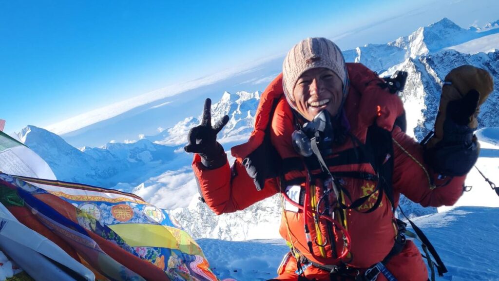 Escaladora en la zona de la muerte del Everest con equipo de oxígeno y paisaje nevado