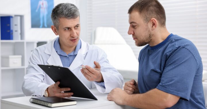 Médico revisando análisis de sangre y gráficos de salud para chequeos después de los 40